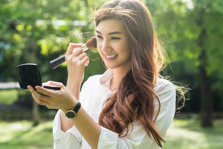 Portrait of beautiful asian young woman make up to her face in the park, Beauty and fashion concept