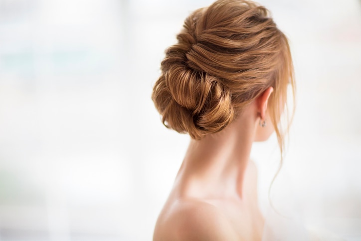 Beautiful elegant wedding hairstyle. Bride. Blond girl with curly hair styling