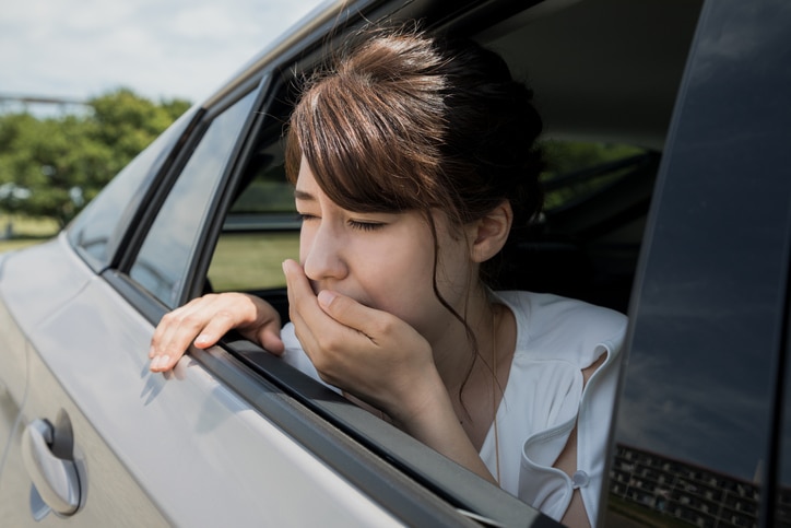 young woman getting carsickness.