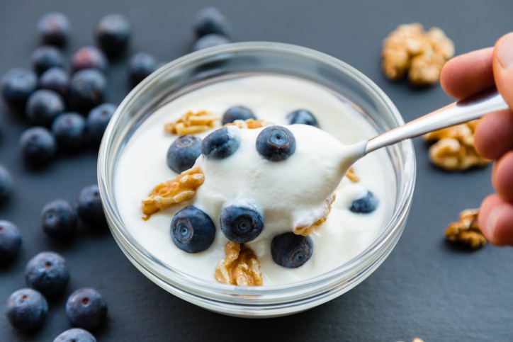 Plain full-fat yogurt (Greek Yogurt) on slate background.