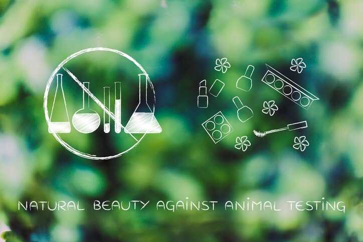 organic vegan make-up concept: crossed out  lab phials next to cosmetics product with flowers