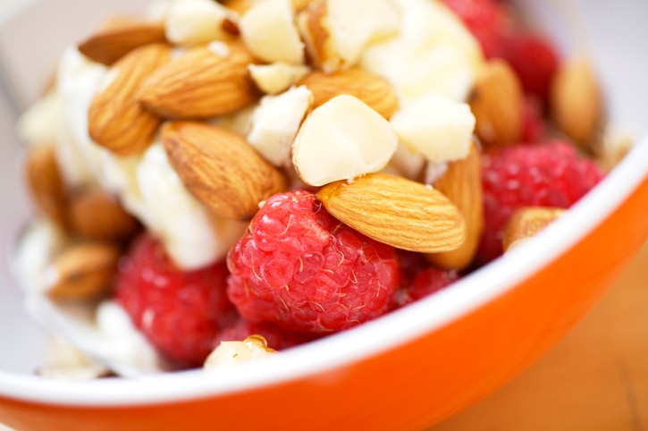 "Bowl of muesli with Greek yogurt, raspberries, honey and nuts"