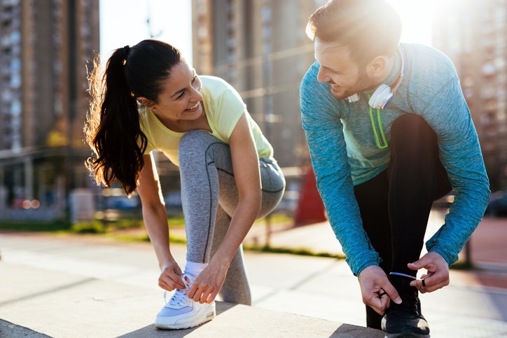 Runners tying their running shoes and getting ready for long run