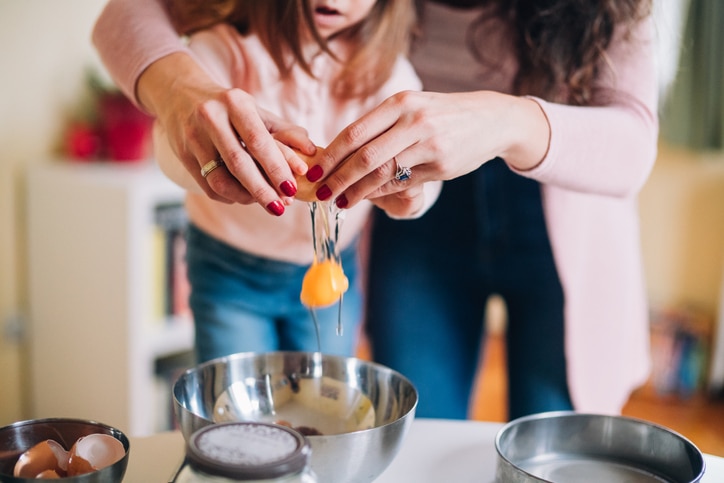 Mother learning her daughter to cook