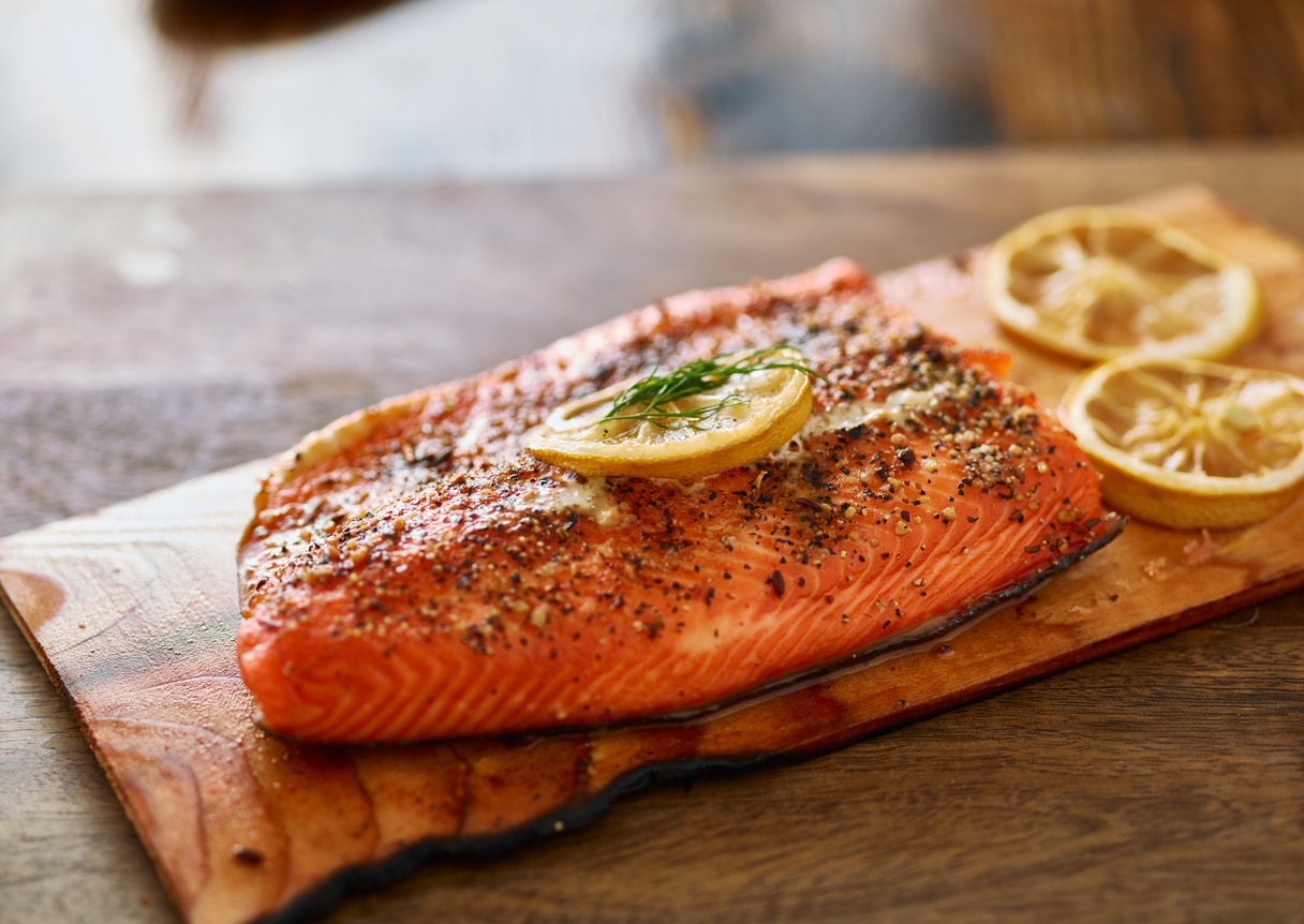 cooked cedar planked salmon with lemon and dill meal