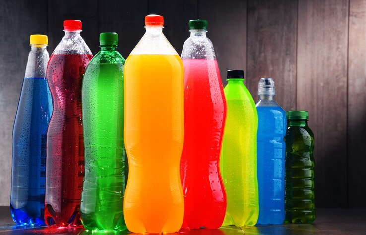 Plastic bottles of assorted carbonated soft drinks in variety of colors