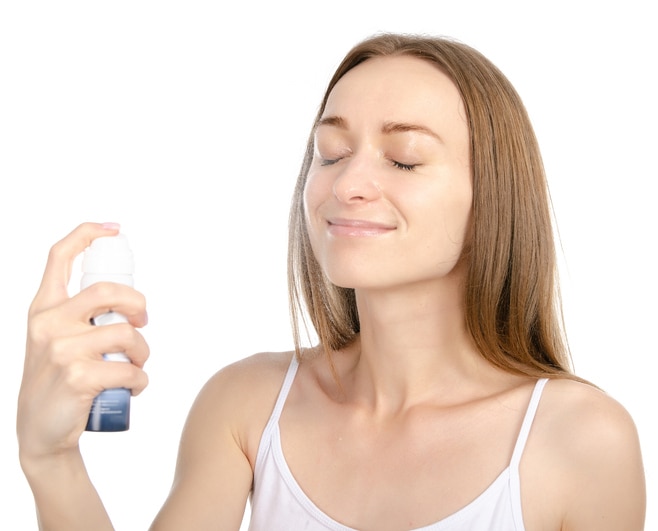 Beautiful woman beauty fashion thermal water spray for face in hand on white background isolation