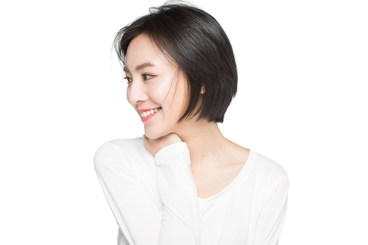 beautiful woman smiling over white background,China.