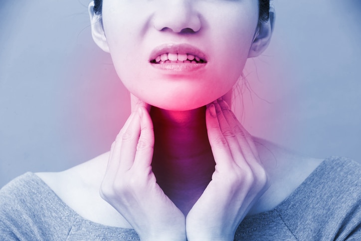 women with thyroid gland problem on the blue background