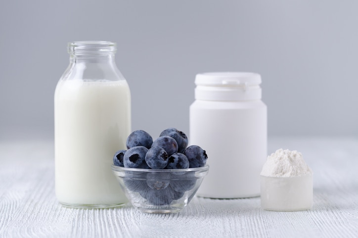 milk products and blueberrys on the table, gray background