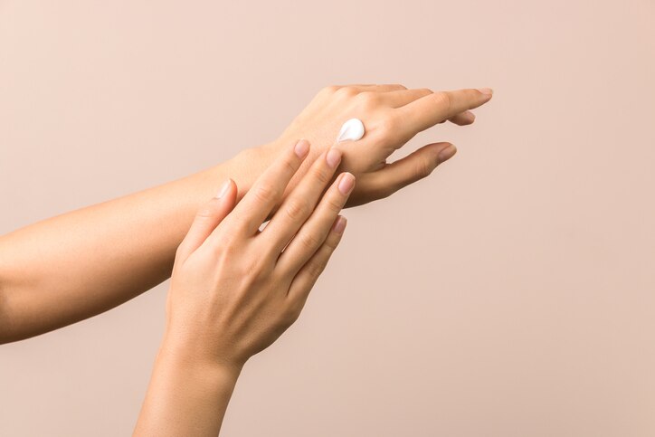 skincare. close up view of woman hand moisturising them with cream. skincare.