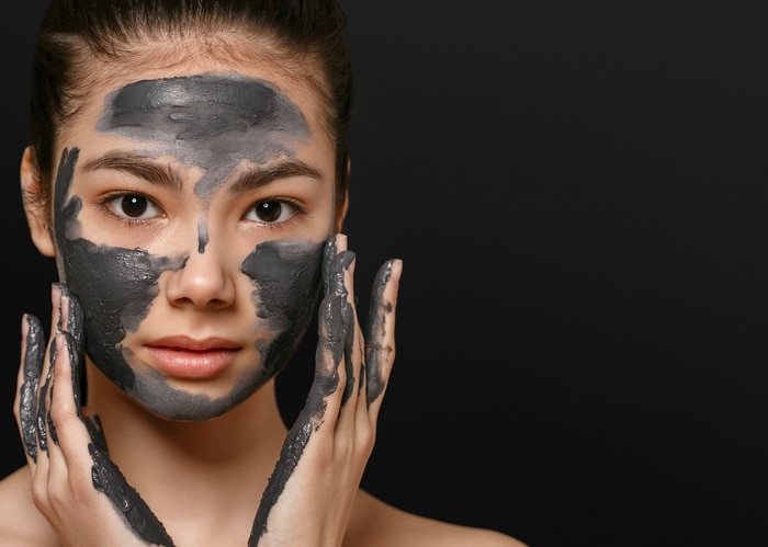 Woman face mask peeling beauty portrait. Cosmetics. Studio shot.