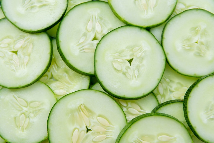 Fresh Cucumber and slices white background.