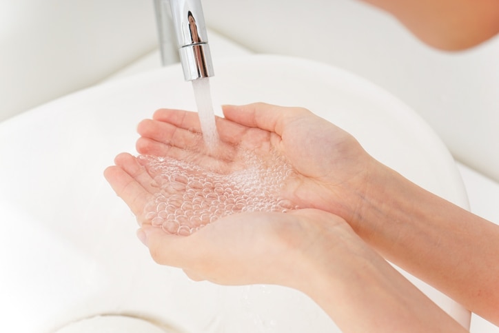 Young woman washing her face