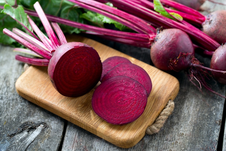 fresh sliced beetroot on wooden surface