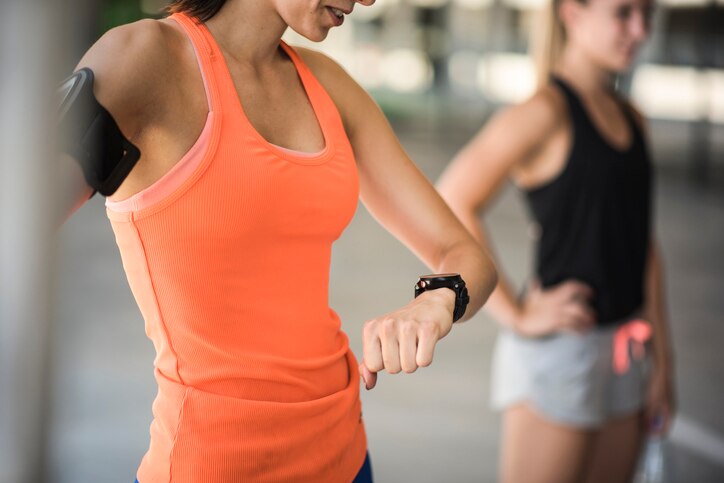 Young woman checking her heartbeat after the run