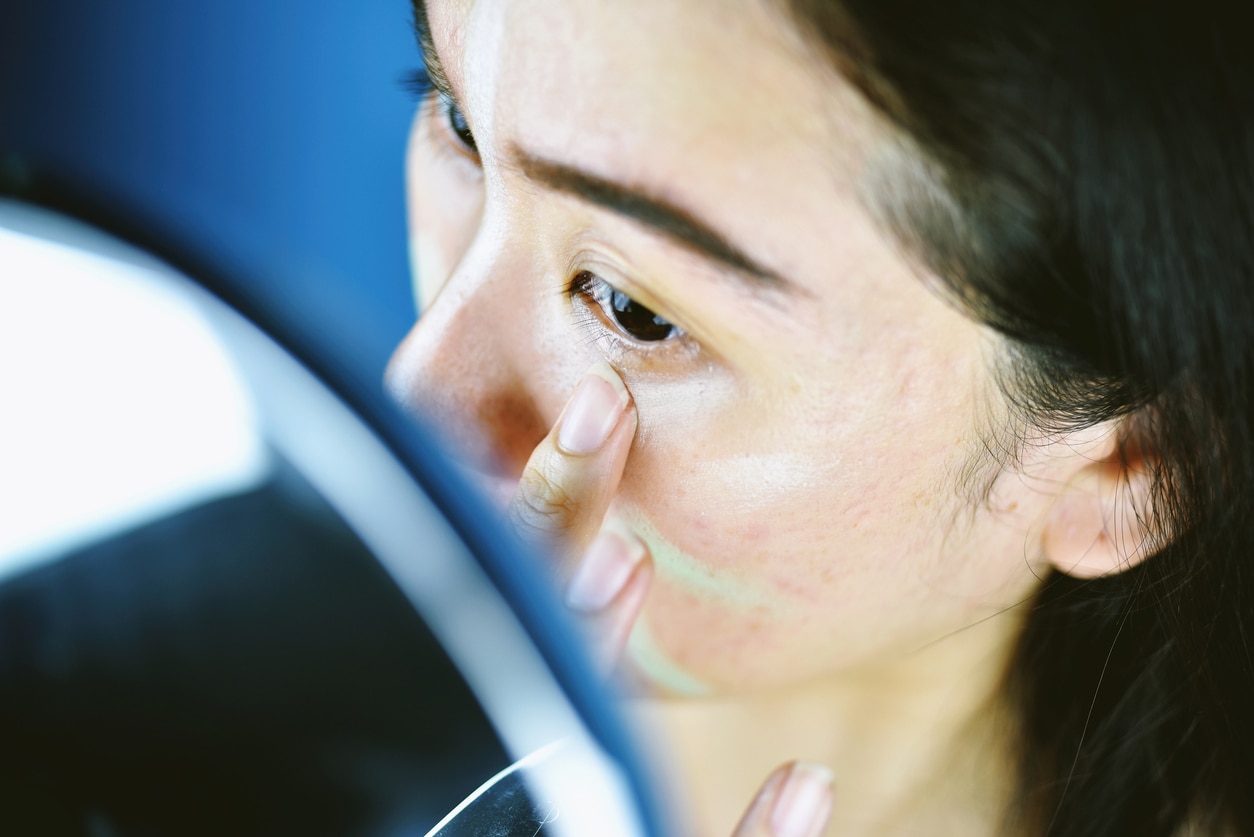 Asian woman applying cosmetics makeup and using color correction concealer, Learning doing self makeup.