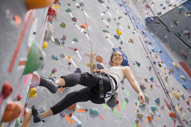 A female climbing a rock wall, MBTI 16 Personalities –  popular leisure activities for ISTP